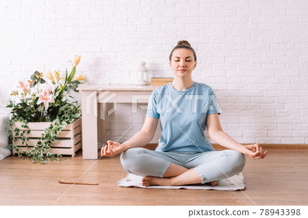 Young girl concentrated in lotus position, yoga at home 78943398