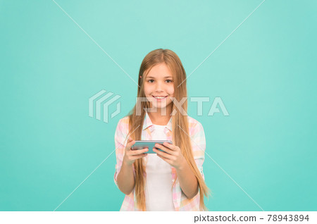 Social experience online. Little girl using mobile phone.  78943894