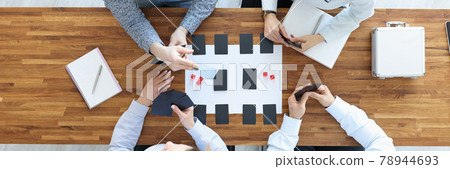 Group of people sitting at table and playing board games top view 78944693