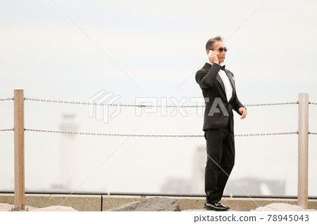 Senior, middle-aged man in a black tie wearing sunglasses Senior, middle-aged man in a black tie wearing sunglasses 78945043