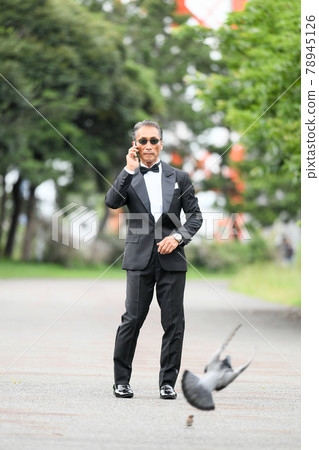 Image of a successful man wearing a black tie wearing sunglasses Image of a successful man wearing a black tie wearing sunglasses 78945126