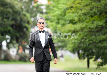 Image of a successful man wearing a black tie wearing sunglasses 78945219