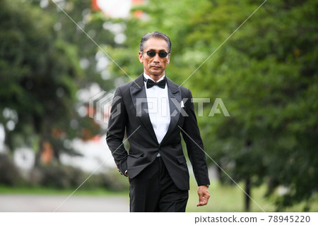 Image of a successful man wearing a black tie wearing sunglasses Image of a successful man wearing a black tie wearing sunglasses 78945220