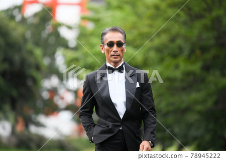 Image of a successful man wearing a black tie wearing sunglasses 78945222