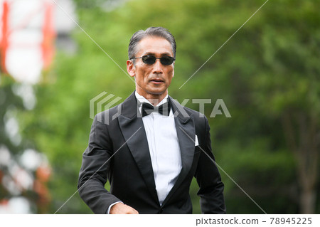 Image of a successful man wearing a black tie wearing sunglasses 78945225