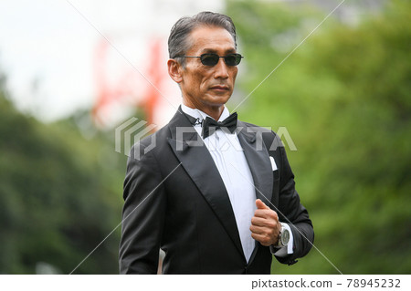 Image of a successful man wearing a black tie wearing sunglasses Image of a successful man wearing a black tie wearing sunglasses 78945232