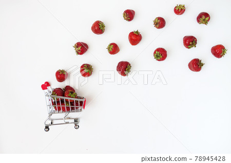 Fresh juicy strawberries in a food cart, isolated on a white bac 78945428