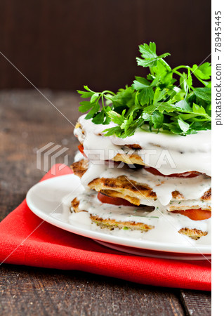 zucchini cake watered sauce on a red napkin zucchini cake watered sauce on a red napkin 78945445