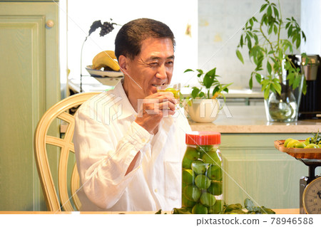 Senior man drinking Umesh and smiling 78946588