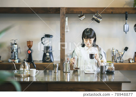 A young woman brewing coffee in a fashionable space A young woman brewing coffee in a fashionable space 78948877
