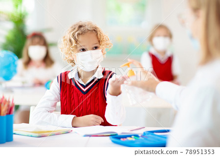 Hand sanitizer in school. Child in face mask. Hand sanitizer in school. Child in face mask. 78951353