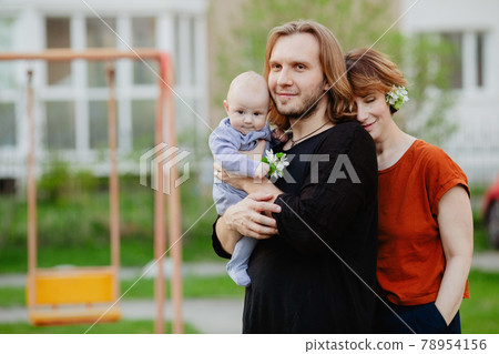 Happy family with baby on playground outdoors Happy family with baby on playground outdoors 78954156