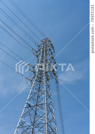 A steel tower with a blue sky and power lines 78955181