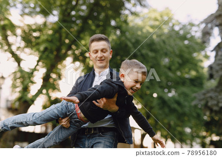Cute family playing in a summer park Cute family playing in a summer park 78956180