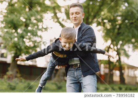Cute family playing in a summer park Cute family playing in a summer park 78956182