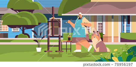 senior woman artist with dog painting picture creative hobby concept full length 78956197