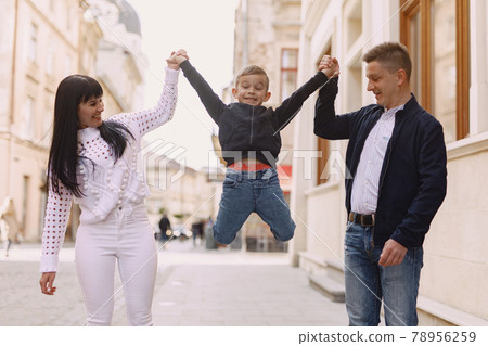 Cute family playing in a summer city 78956259