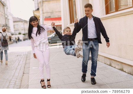 Cute family playing in a summer city 78956270