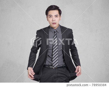 young businessman  holding his empty pockets, 78958384