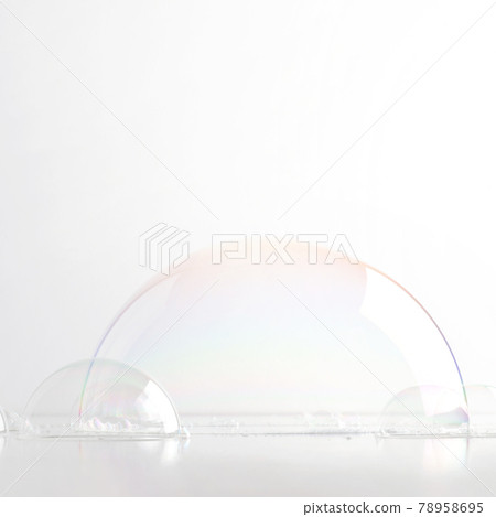 A hemisphere of a transparent soap bubble mockup for the presentation of cosmetics. White clean light background. A hemisphere of a transparent soap bubble mockup for the presentation of cosmetics. White clean light background. 78958695
