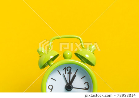 black vintage alarm clock on yellow color background black vintage alarm clock on yellow color background 78958814