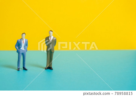 Mannequins of men stand on a yellow background. Mannequins of men stand on a yellow background. 78958815