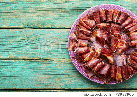 Spicy beef jerky on wooden background,copy space 78958900