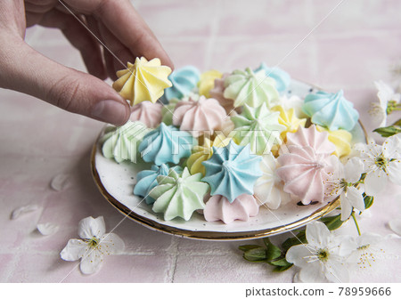 Small colorful meringues in the ceramic  plate 78959666