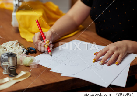 Fashion designer drawings with a pencil sketches Fashion designer drawings with a pencil sketches 78959954