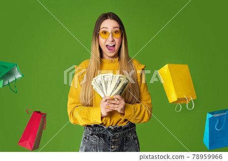 woman holds cash money under dollar's rain. 78959966