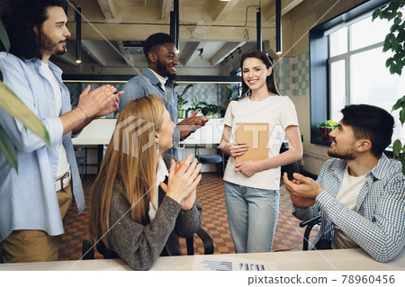 Group of young business people applaud their female colleague after presentation 78960456