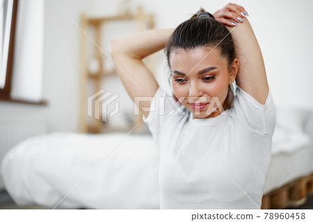 Young fit woman doing stretching exercises at home Young fit woman doing stretching exercises at home 78960458