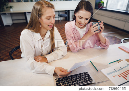 Two women entrepreneurs working together in office Two women entrepreneurs working together in office 78960465