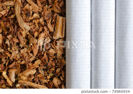 Classic cigarettes are next to tobacco. Top view. 78960934