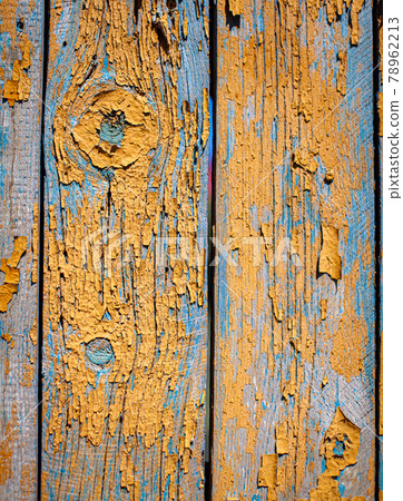 Wood texture with yellow flaked paint. Peeling paint on weathered wood 78962213