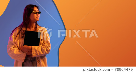 Contemporary art collage, modern design. Retro style. Woman on colored studio background in magazine style. Blue and orange 78964479