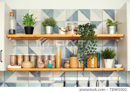 A variety of pasta in containers-cans with bulk products stand on shelves 78965002