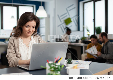 Close up of satisfied businesswoman answering email 78965087