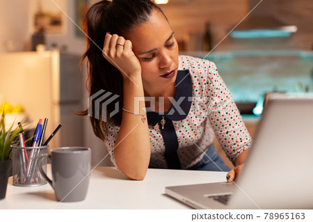 Woman resting eyes while working Woman resting eyes while working 78965163