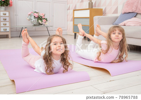 Full length front view smiling cute girls sitting on on yoga mat 78965788