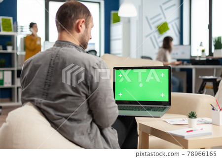 Business team sitting on couch analysing financial statistics 78966165