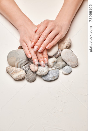 Woman hands with beautiful manicure on light background Woman hands with beautiful manicure on light background 78966166