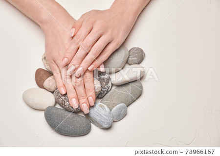 Woman hands with beautiful manicure on light background Woman hands with beautiful manicure on light background 78966167