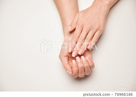 Woman hands with beautiful manicure on light background Woman hands with beautiful manicure on light background 78966186