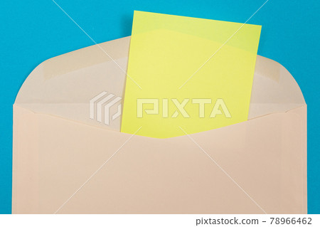 Beige Envelope with Blank Yellow Sheet of Paper Inside Beige Envelope with Blank Yellow Sheet of Paper Inside 78966462