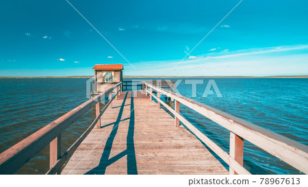 Wooden Pier For Fishing, Small House Shed And Beautiful Lake Or River In Background. Picturesque Natural Landscape In Berezinsky, Biosphere Reserve, Belarus 78967613