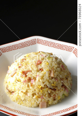 Photographed a single Gomoku fried rice with various ingredients such as Narutomaki and char siu on a black background Photographed a single Gomoku fried rice with various ingredients such as Narutomaki and char siu on a black background 78968024