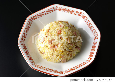 A bird's-eye view of a single Gomoku fried rice with various ingredients such as Narutomaki and char siu on a black background 78968038