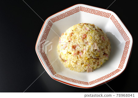 A bird's-eye view of a single Gomoku fried rice with various ingredients such as Narutomaki and char siu on a black background 78968041