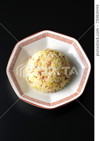A bird's-eye view of a single Gomoku fried rice with various ingredients such as Narutomaki and char siu on a black background A bird's-eye view of a single Gomoku fried rice with various ingredients such as Narutomaki and char siu on a black background 78968048